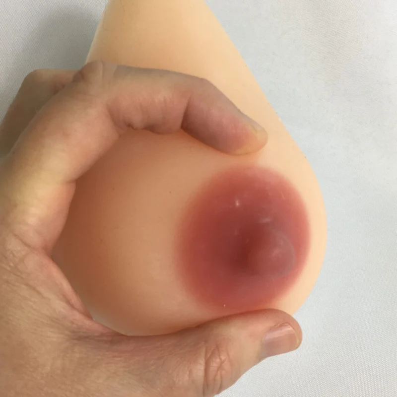 A person's hand demonstrating how to express milk or colostrum from a breast