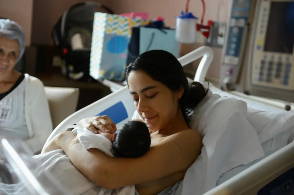 A woman holding a baby in her arms.