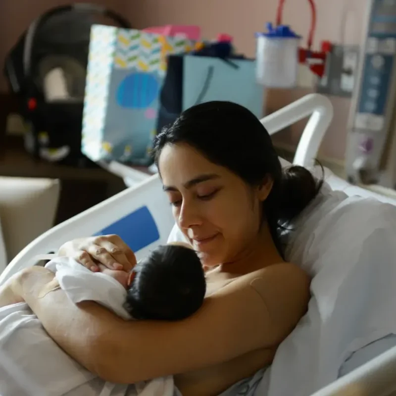 A woman holding a baby in her arms.