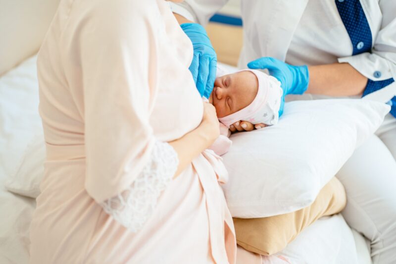 Breastfeeding mother getting help with breastfeeding her baby