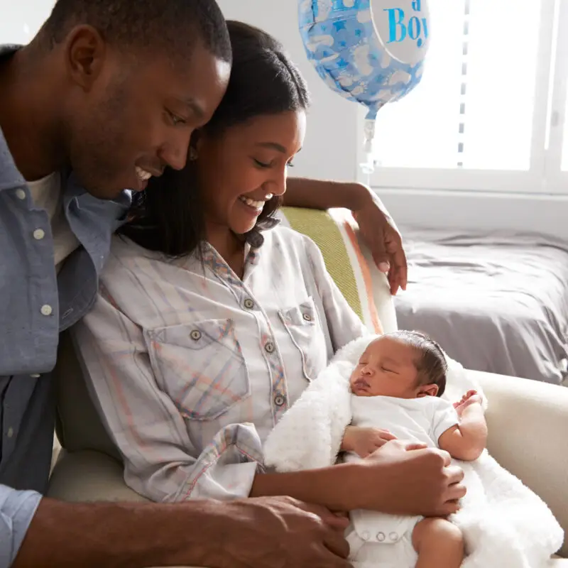 A man and woman holding a baby in their arms.