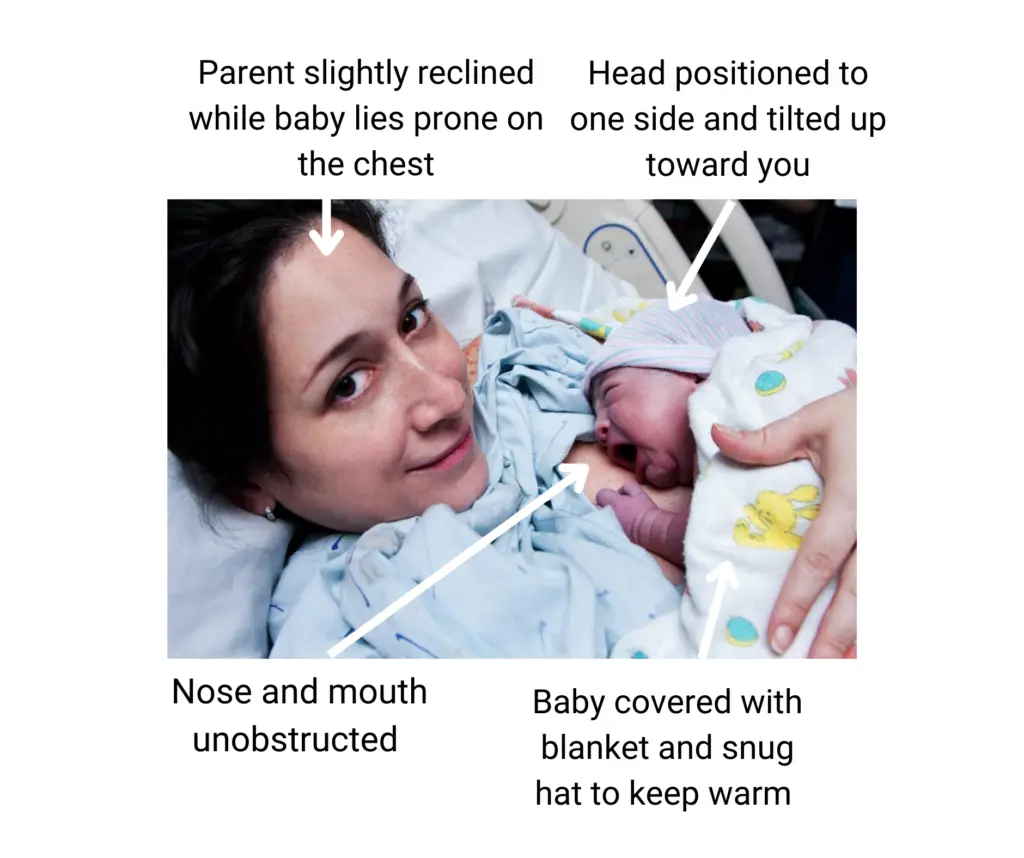A woman holding a baby in her arms.