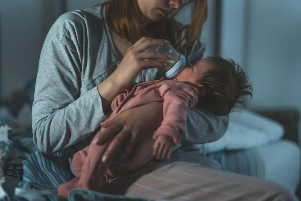 A woman holding a baby in her arms.