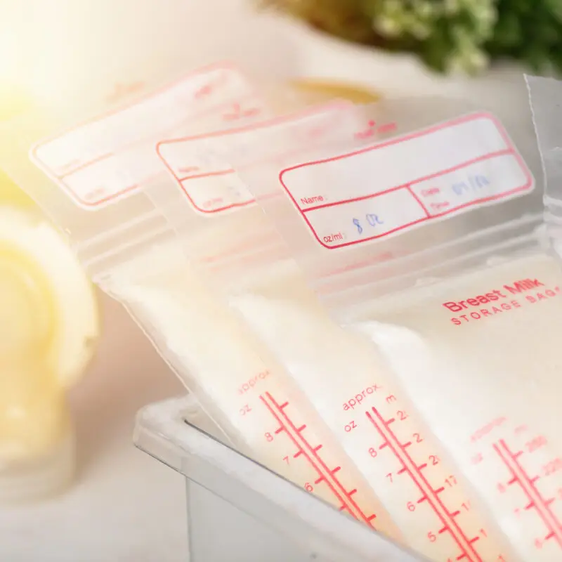 A close up of some breast milk bags in a bin