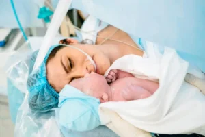 Mother and newborn share a tender moment.