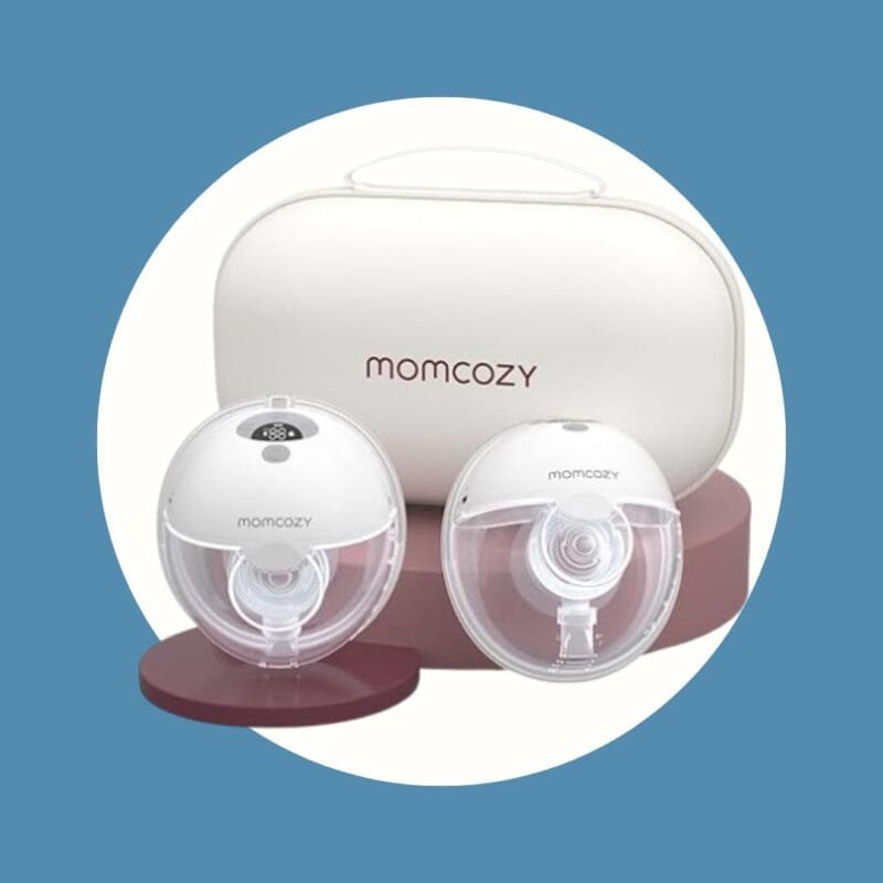 clear and white egg shaped breast pump parts next to a white storage bag