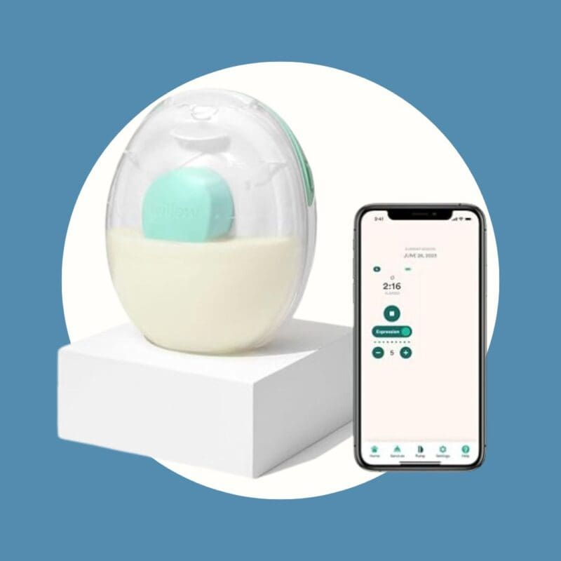 clear egg shaped milk holder with milk in the bottom next to a cell phone with a timer.