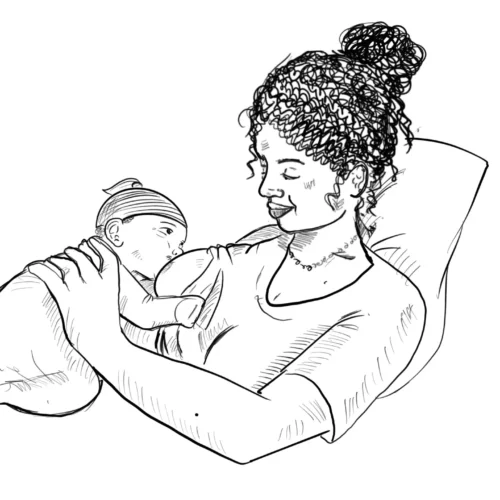 A woman holding a baby in her arms.